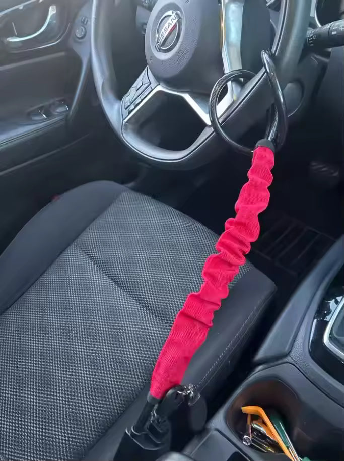 SteerShield anti-theft steering wheel lock fitted to a car
SteerShield steel cable resisting bolt cutters
SteerShield hardened lock core close-up
SteerShield steering wheel and seat belt lock universal fit
Driver installing SteerShield car security lock in seconds