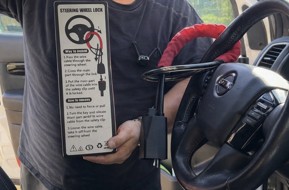 SteerShield anti-theft steering wheel lock fitted to a car
SteerShield steel cable resisting bolt cutters
SteerShield hardened lock core close-up
SteerShield steering wheel and seat belt lock universal fit
Driver installing SteerShield car security lock in seconds